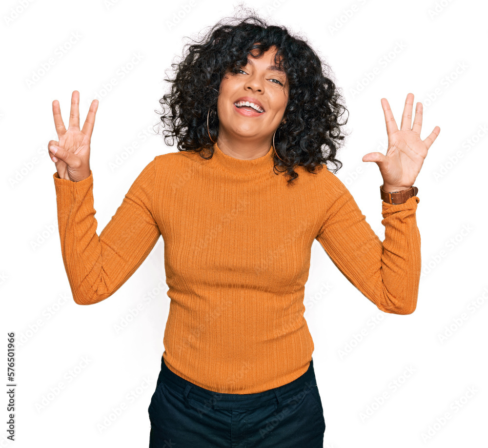 Young hispanic woman wearing casual clothes showing and pointing up with fingers number eight while smiling confident and happy. Young hispanic woman wearing casual clothes showing and pointing up with fingers number eight while smiling confident and happy.
