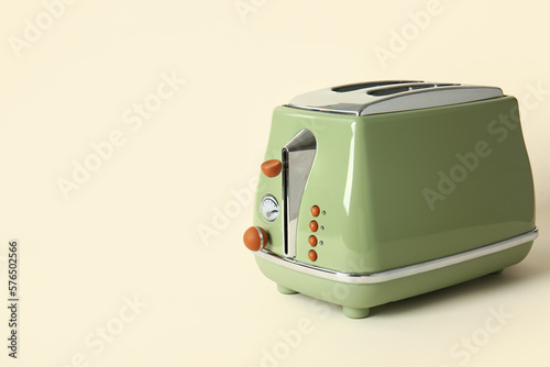 Modern toaster on beige background