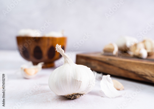 Garlic on a wooden board, white background, text space