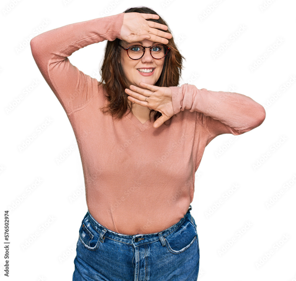Young plus size woman wearing casual clothes and glasses smiling cheerful playing peek a boo with hands showing face. surprised and exited Young plus size woman wearing casual clothes and glasses smiling cheerful playing peek a boo with hands showing face. surprised and exited