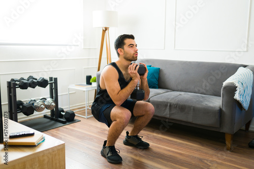 Fototapeta Naklejka Na Ścianę i Meble -  Handsome man exercising in his home gym