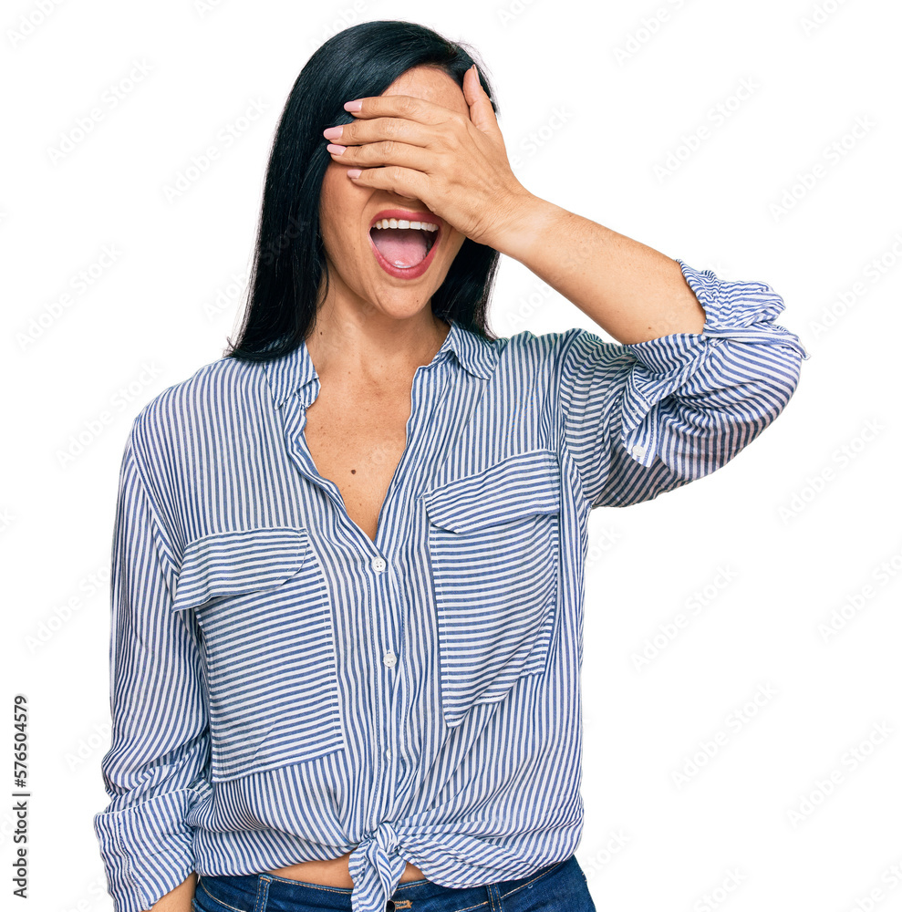Young caucasian woman wearing casual clothes smiling and laughing with hand on face covering eyes for surprise. blind concept. Young caucasian woman wearing casual clothes smiling and laughing with hand on face covering eyes for surprise. blind concept.