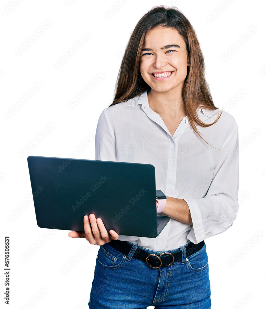 Young caucasian girl holding laptop looking positive and happy standing and smiling with a confident smile showing teeth Young caucasian girl holding laptop looking positive and happy standing and smiling with a confident smile showing teeth