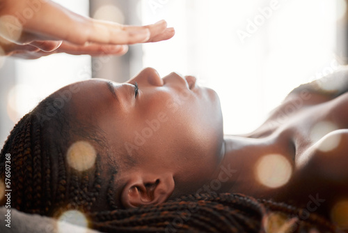 Black woman, relax and reiki spa treatment of a young female ready for facial. Skincare, beauty and salon wellness clinic with client feeling calm and zen from massage and holistic dermatology