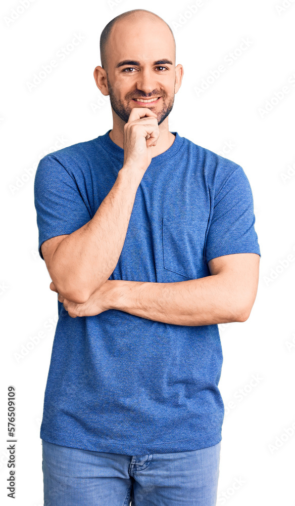 Young handsome man wearing casual t shirt looking confident at the camera with smile with crossed arms and hand raised on chin. thinking positive. Young handsome man wearing casual t shirt looking confident at the camera with smile with crossed arms and hand raised on chin. thinking positive.