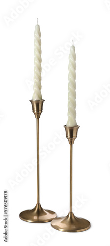 Vintage metal candlesticks with candles on white background