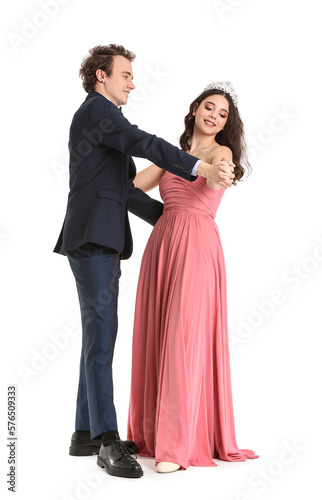 Beautiful couple dressed for prom dancing on white background