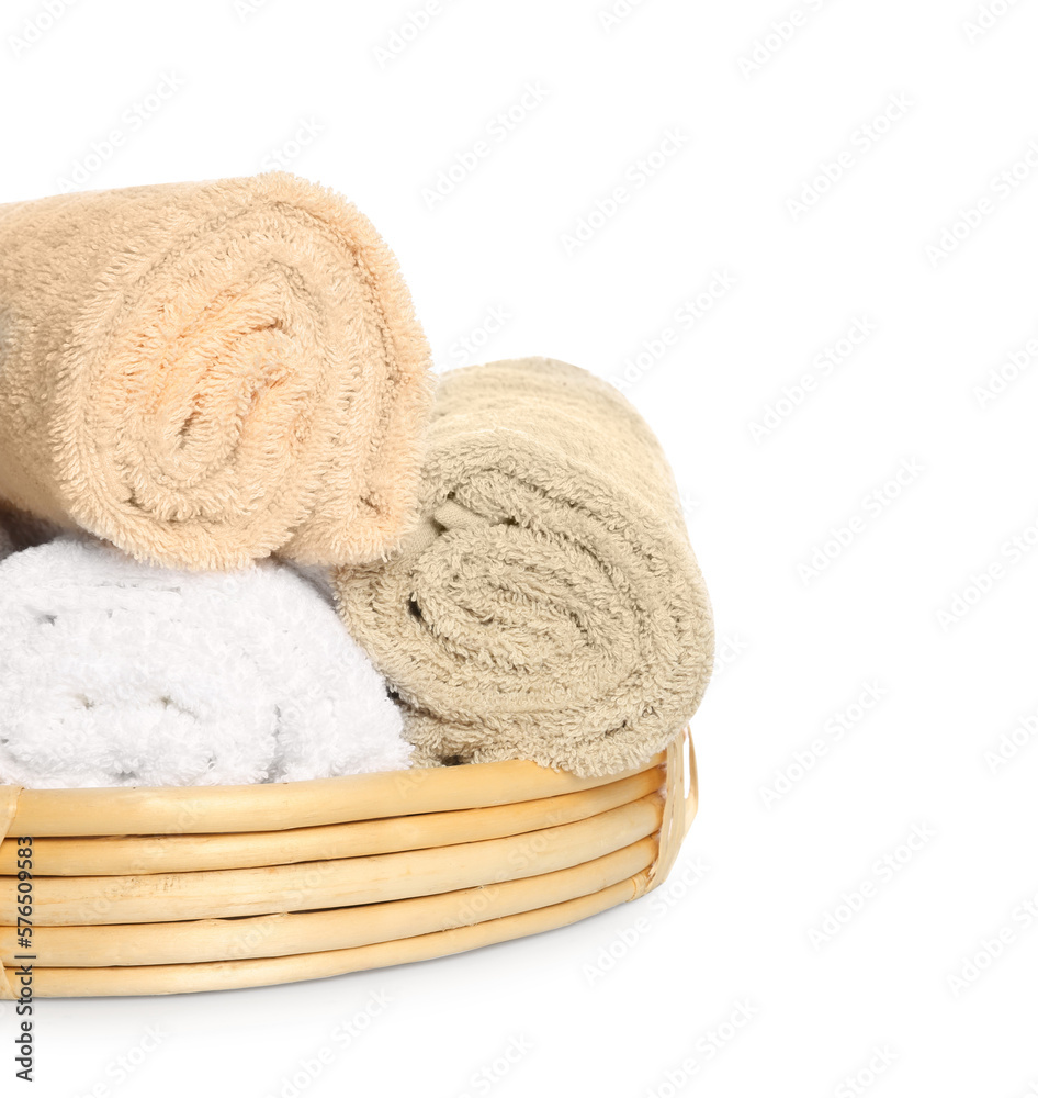 Wicker basket with rolled bath towels isolated on white Wicker basket with rolled bath towels isolated on white