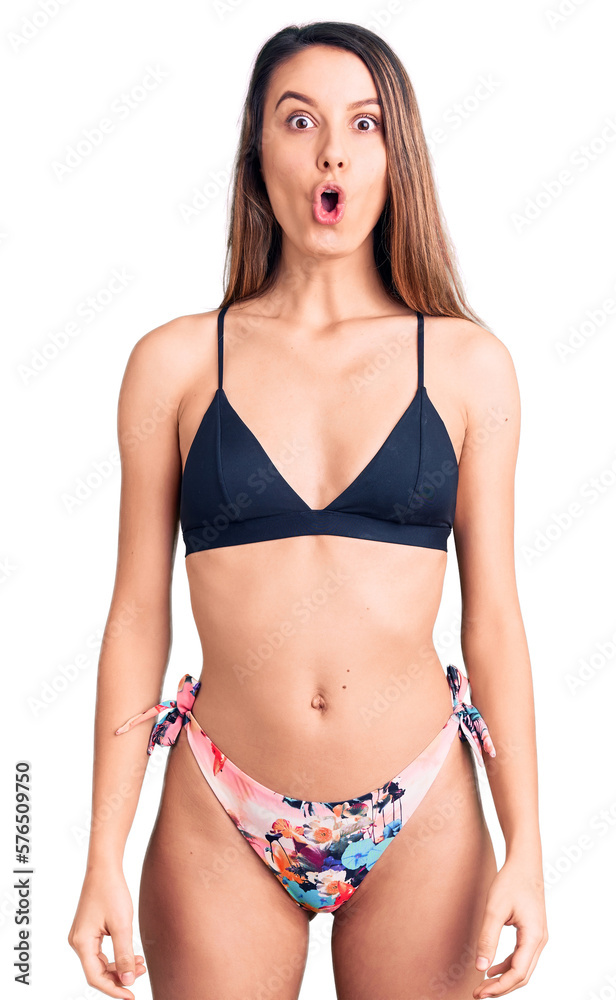 Young beautiful girl wearing bikini scared and amazed with open mouth for surprise, disbelief face Young beautiful girl wearing bikini scared and amazed with open mouth for surprise, disbelief face