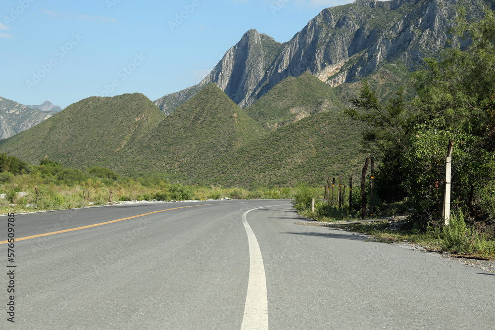Fototapeta premium Beautiful view of empty asphalt highway near mountains outdoors. Road trip