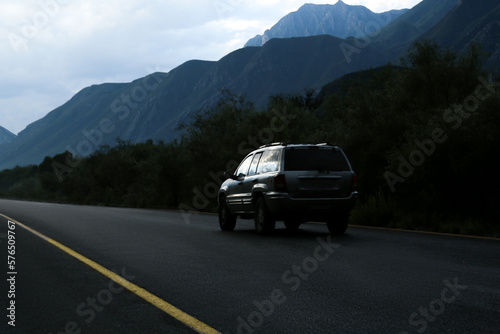 Beautiful view of car on asphalt highway in mountains. Road trip
