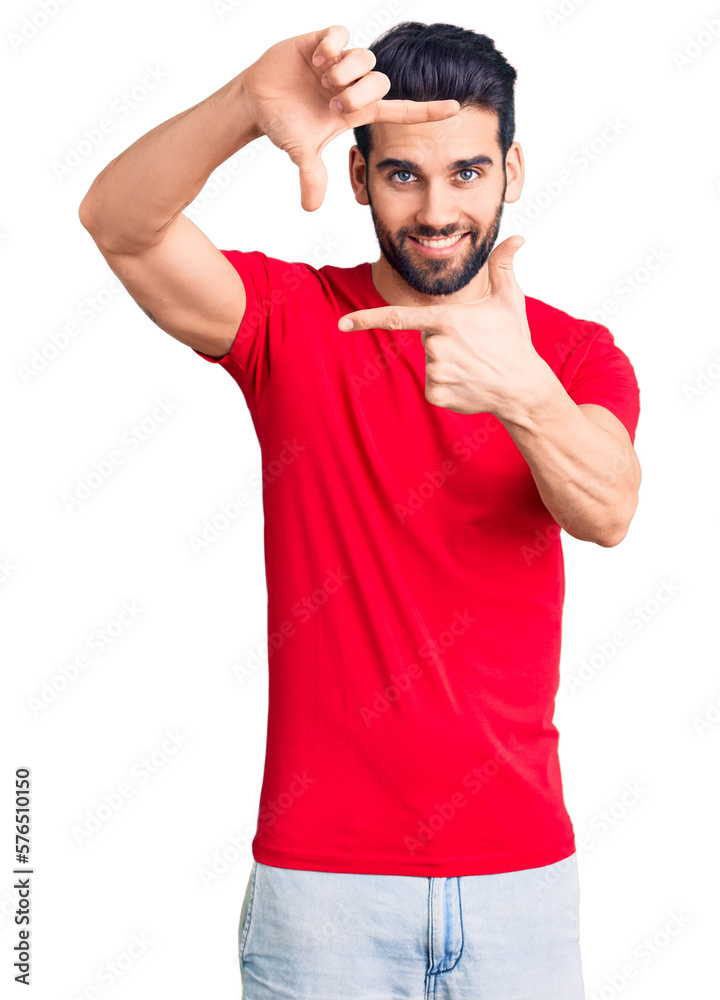 Young handsome man with beard wearing casual t-shirt smiling making frame with hands and fingers with happy face. creativity and photography concept.