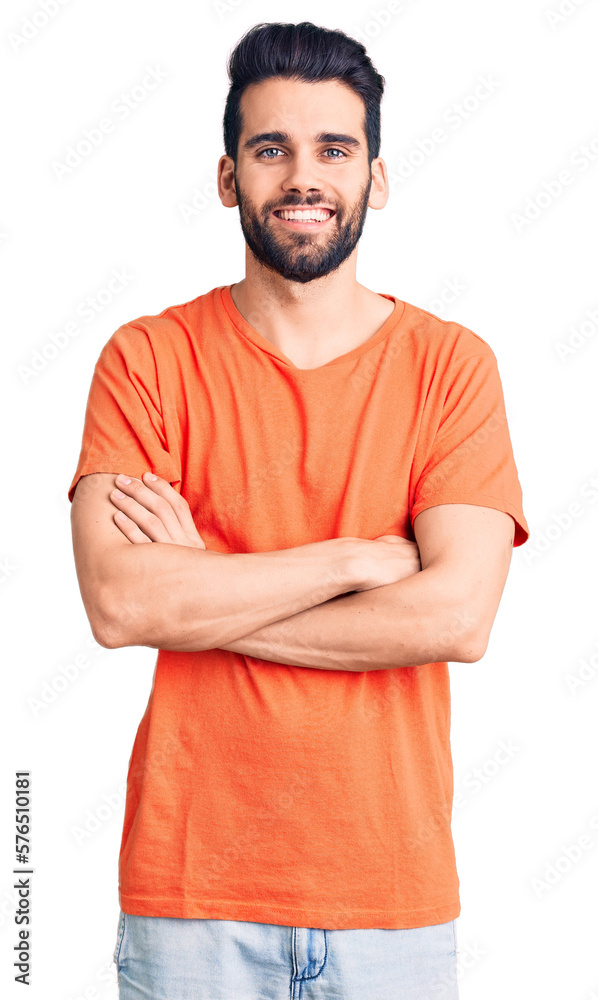 Obraz premium Young handsome man with beard wearing casual t-shirt happy face smiling with crossed arms looking at the camera. positive person.