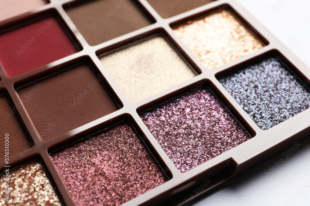 Fototapeta premium Beautiful eye shadow palette on white table, closeup