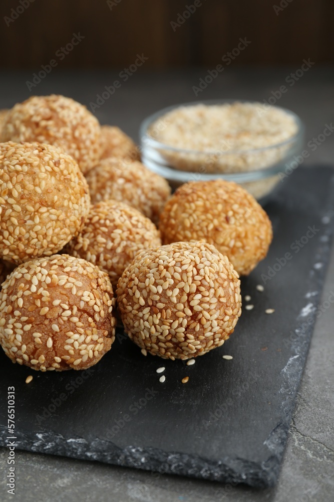 Many delicious sesame balls on grey table, closeup Many delicious sesame balls on grey table, closeup