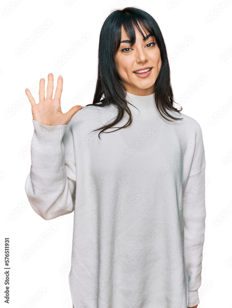 Young brunette woman with bangs wearing casual turtleneck sweater showing and pointing up with fingers number five while smiling confident and happy. Young brunette woman with bangs wearing casual turtleneck sweater showing and pointing up with fingers number five while smiling confident and happy.