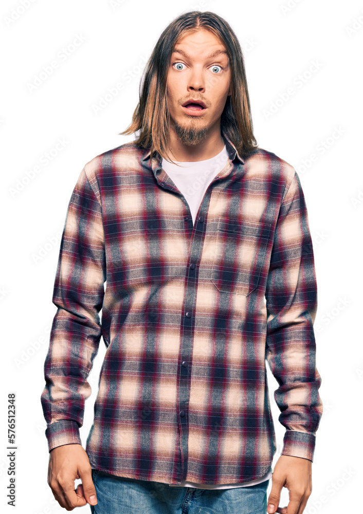 Handsome caucasian man with long hair wearing hipster shirt afraid and shocked with surprise expression, fear and excited face. Handsome caucasian man with long hair wearing hipster shirt afraid and shocked with surprise expression, fear and excited face.