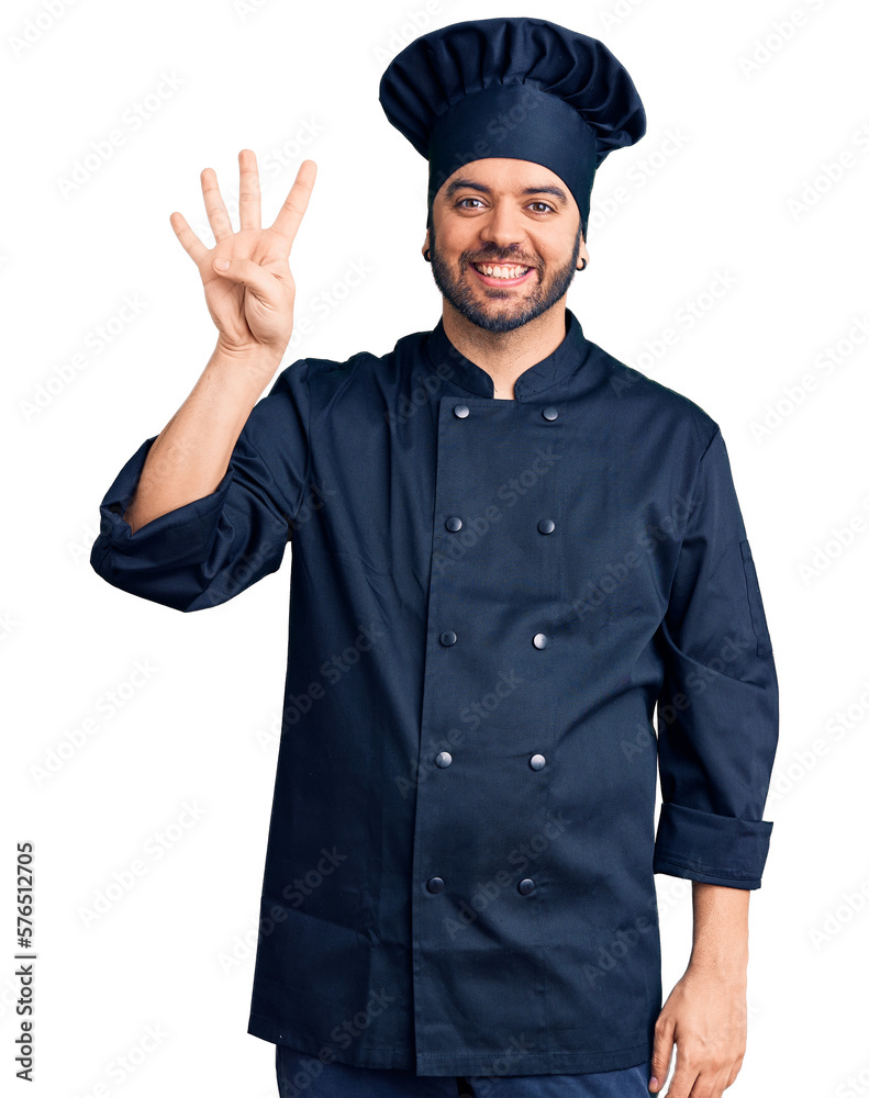 Young hispanic man wearing cooker uniform showing and pointing up with fingers number four while smiling confident and happy. Young hispanic man wearing cooker uniform showing and pointing up with fingers number four while smiling confident and happy.