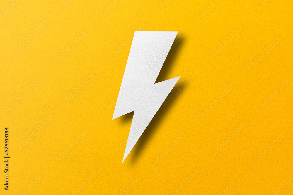 Paper cut lightning shape, lightning with light and shadow. placed on a yellow paper background Paper cut lightning shape, lightning with light and shadow. placed on a yellow paper background