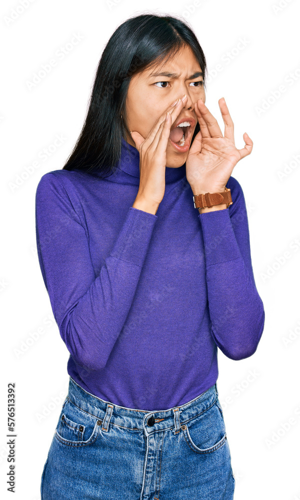Beautiful young asian woman wearing casual clothes shouting angry out loud with hands over mouth Beautiful young asian woman wearing casual clothes shouting angry out loud with hands over mouth