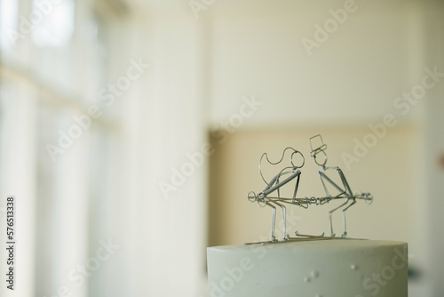 wedding cake topper with mini wire statue of bride and groom on skis