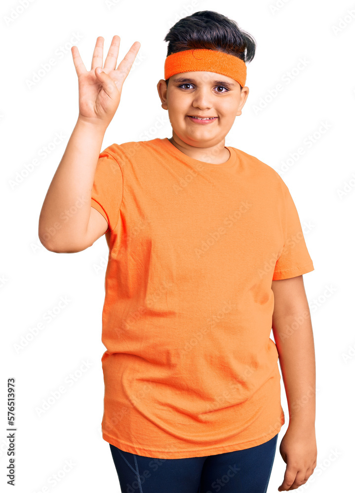 Little boy kid wearing sportswear showing and pointing up with fingers number four while smiling confident and happy. Little boy kid wearing sportswear showing and pointing up with fingers number four while smiling confident and happy.