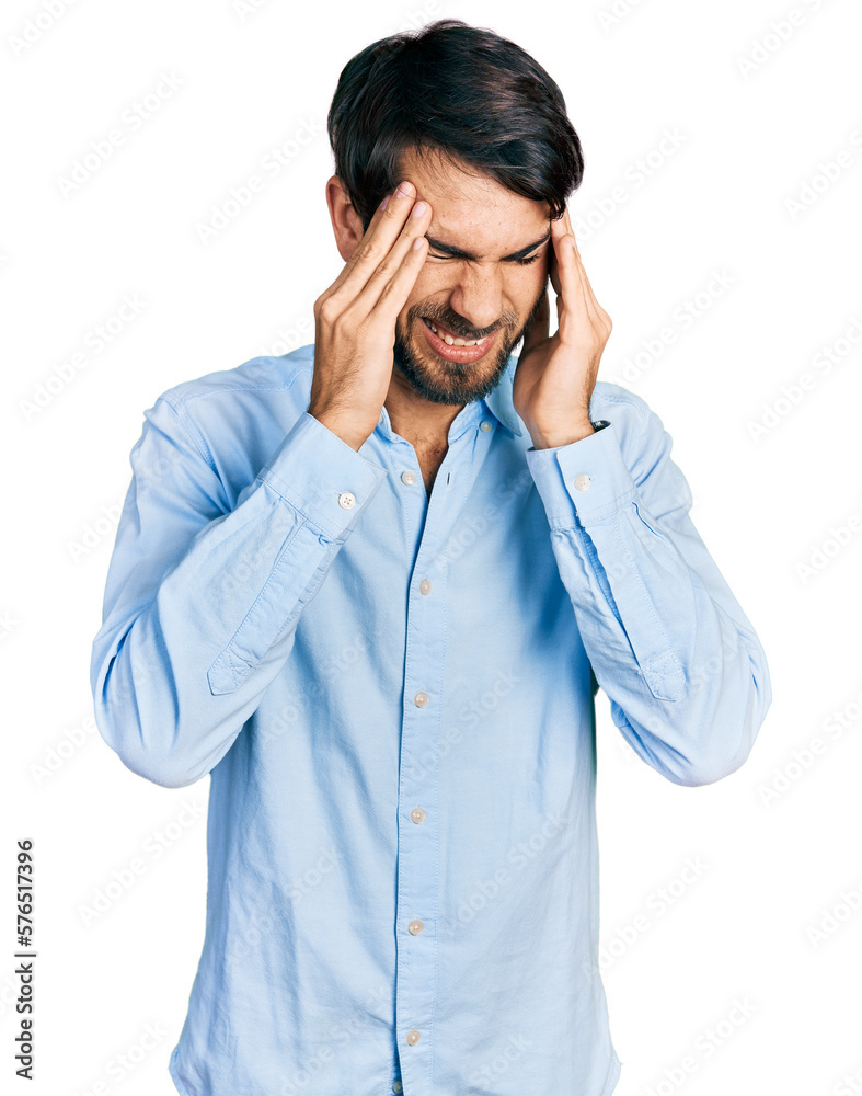 Hispanic man with blue eyes wearing business shirt with hand on head, headache because stress. suffering migraine. Hispanic man with blue eyes wearing business shirt with hand on head, headache because stress. suffering migraine.