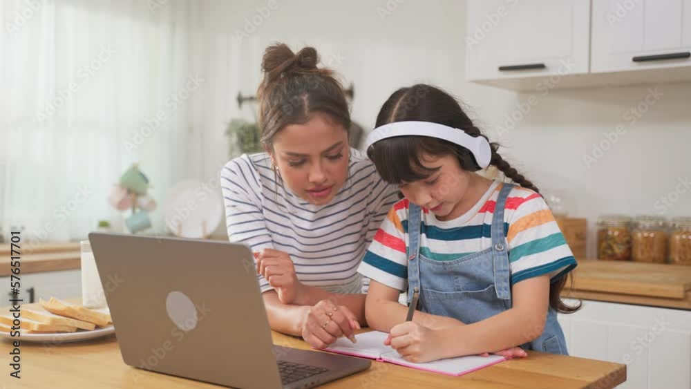 Caucasian young girl kid learning online class at home with mother. Caucasian young girl kid learning online class at home with mother.