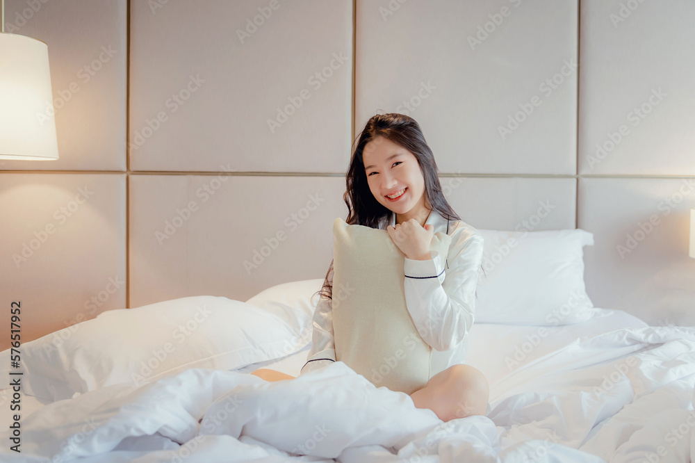 Asian teenage girl resting on the mattress After a full night's sleep And working in the morning in the bedroom. She is cheerful, bright, and happy. Asian teenage girl resting on the mattress After a full night's sleep And working in the morning in the bedroom. She is cheerful, bright, and happy.