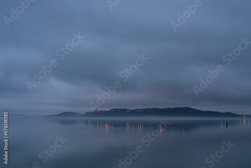 Tihany peninsula on a foggy winter day from Balatonfured photo