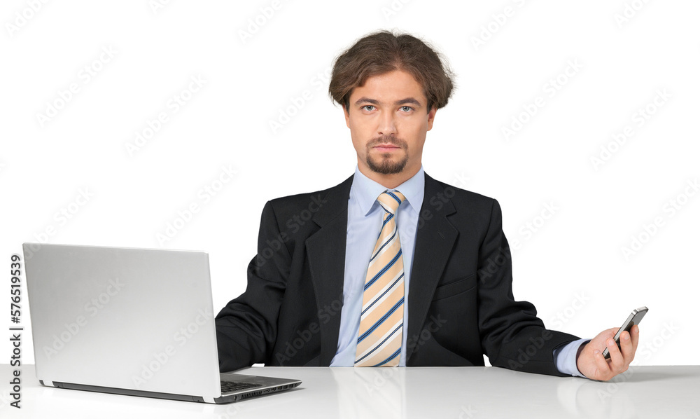 Portrait of a Serious Businessman Working with Laptop and Holding a Smartphone Portrait of a Serious Businessman Working with Laptop and Holding a Smartphone