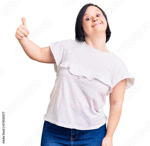 Slika na platnu Brunette woman with down syndrome wearing casual white tshirt looking proud, smi