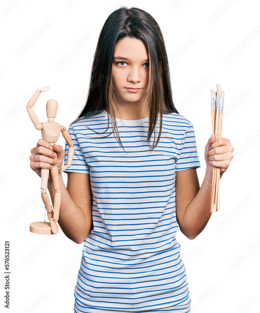 Young brunette girl with long hair holding small wooden manikin and pencils skeptic and nervous, frowning upset because of problem. negative person. Young brunette girl with long hair holding small wooden manikin and pencils skeptic and nervous, frowning upset because of problem. negative person.
