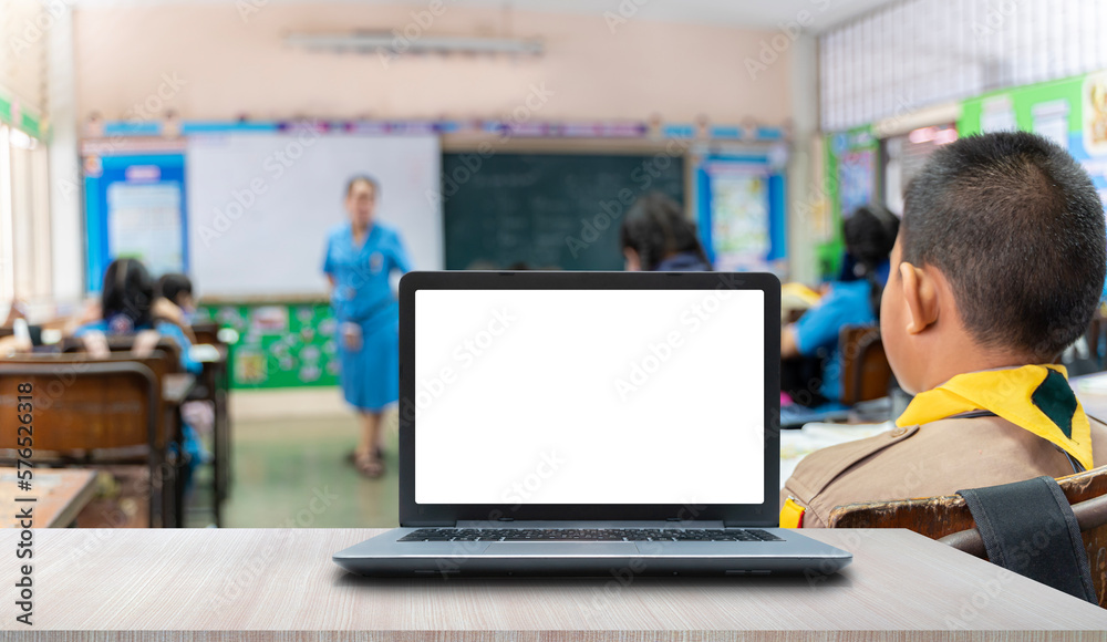 Background image of opened laptop with blank white screen on teachers desk in school auditorium, copy space Background image of opened laptop with blank white screen on teachers desk in school auditorium, copy space