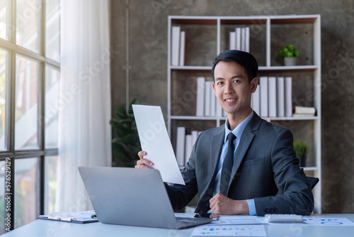 Busy businessman accountant Asian male making look document in office working, , report, tax, accounting, statistics, and analytic research concept