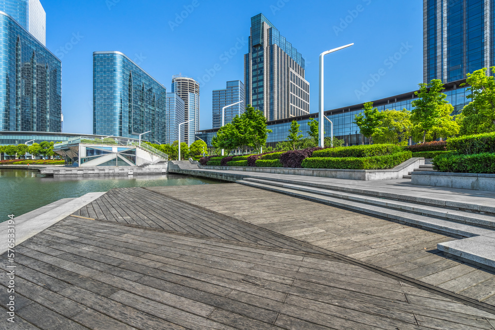 Empty wooden footpath front modern building.