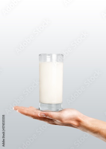 Hand holding glass of fresh milk