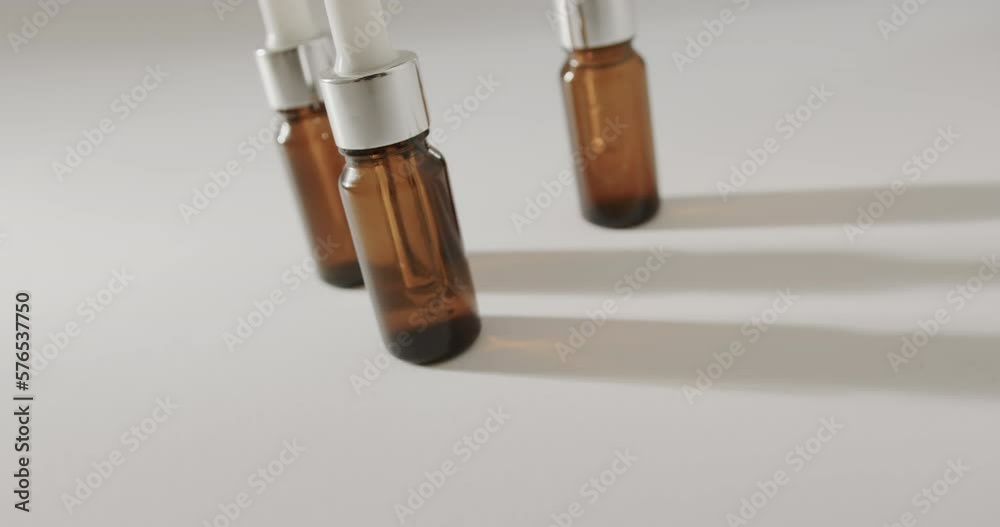 Close up of three glass bottles with pumps with copy space on white background Close up of three glass bottles with pumps with copy space on white background