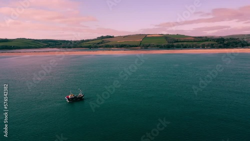 A Drone shot circling a fishing boat on the 18.2.2023 off the Devon Coast England near Torcross. Coast in back ground photo