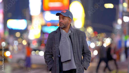 Afro-American man walking in Manhattan at night - travel photography