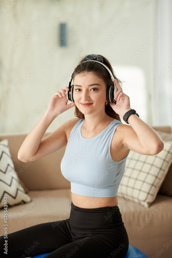 Sporty girl working out of fitness ball at home Sporty girl working out of fitness ball at home