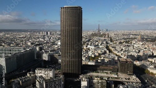 Montparnasse tower and urbanscape with Tour Eiffel in background, Paris in France. Aerial drone panoramic view