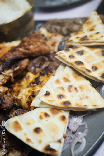 Seekh Kabab, Naan bread, and sauce on a plate 