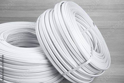 Roll of classic light electric cable on background