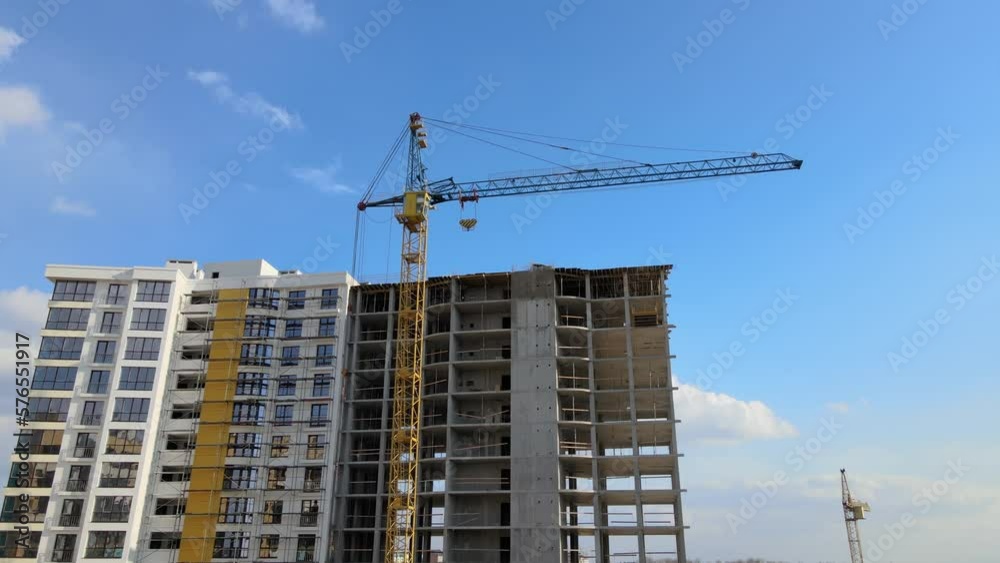 Tower cranes and frame structure of high residential apartment buildings at construction site. Real estate development Tower cranes and frame structure of high residential apartment buildings at construction site. Real estate development