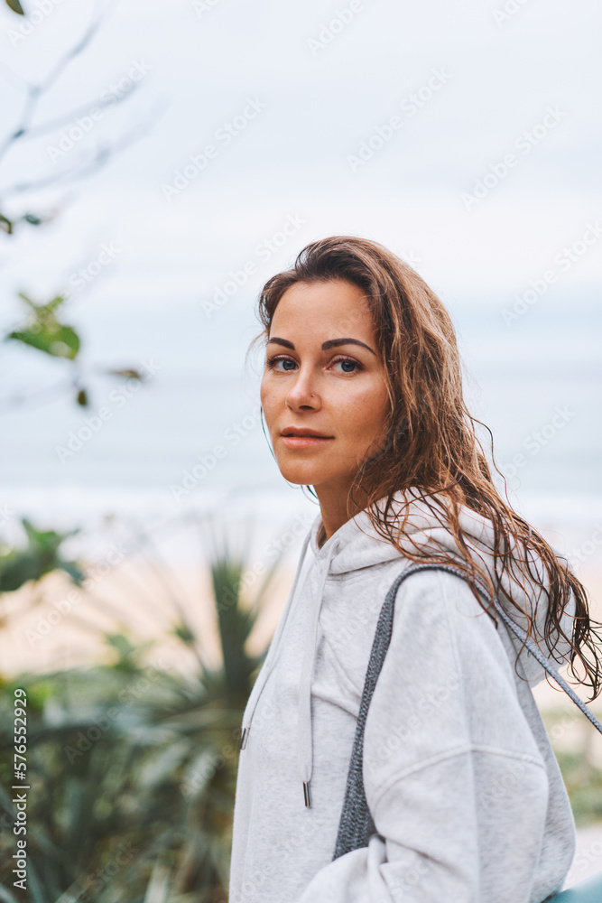 Portrait young girl in peace of mind and body came to yoga exercises on beach, looking in camera Portrait young girl in peace of mind and body came to yoga exercises on beach, looking in camera