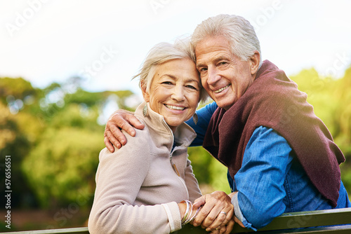 Old couple in portrait, relax in the park with smile, happiness together with bonding in nature, love and retirement. Happy, man and woman with travel, relationship with marriage and commitment