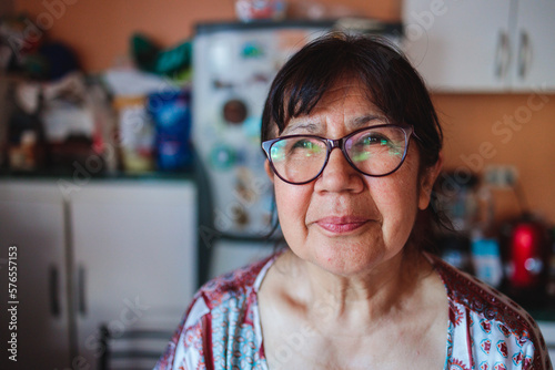 Portrait of a smiling elderly latin woman in her kitchen