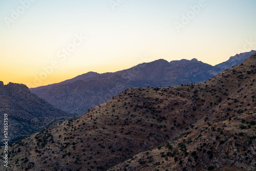 Rolling mountain hills in cliffs and ridges of tuscon arizona in afternoon sunset or early sunrise sun with haze sky