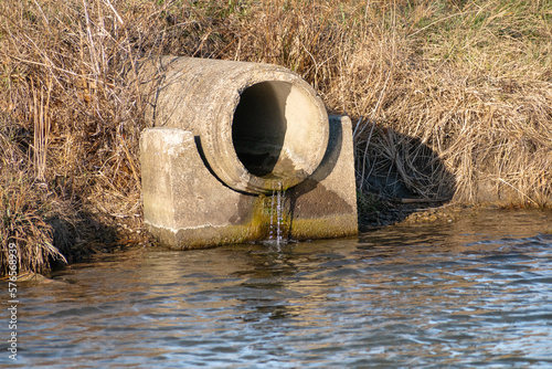Concrete sewer pipe leaking into pond
